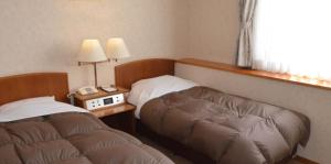 Un pat sau paturi într-o cameră la 雲海の里かもい岳