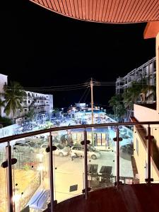 a view of a city at night from a balcony at Hotel Sea Queen Suite & Golf Cart Rental in San Pedro