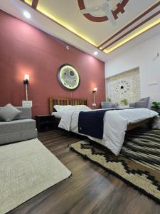 a bedroom with a large bed and a red wall at Kassy homestay in Udaipur