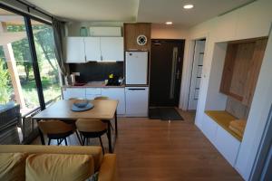 a kitchen and living room with a table and chairs at Brzuchem do góry in Chocieszow