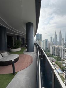 a balcony of a building with a view of a city at Eaton Suites KLCC by Perkasa Ikon in Kuala Lumpur
