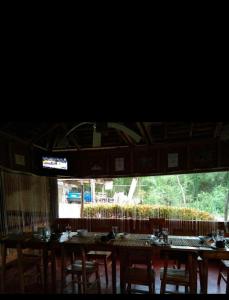 a group of tables in a room with a large window at Star Lotus Guesthouse in Sampong