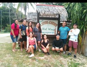 a group of people posing in front of a shack at Star Lotus Guesthouse in Sampong