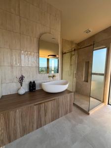 a bathroom with a tub and a sink and a shower at Golden Ridge Retreat in Otorohanga