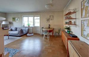 a living room with a couch and a table at Nice Home In Bolmsö With Lake View in Bolmsö
