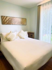 Postel nebo postele na pokoji v ubytování Wyndham Garden Samui Wing