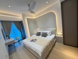 a bedroom with a large bed and a window at Eaton Suites KLCC by Perkasa Ikon in Kuala Lumpur +16 photos