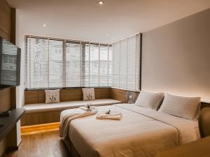 a bedroom with a large bed and a couch at Townhouse PK Garden in Bangkok