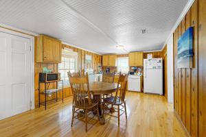 a kitchen with a table and chairs and a refrigerator at Cozy Corner in Folly Beach