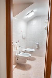 a bathroom with a toilet and a sink at La finestra sulla piazza in Pisticci +12 photos