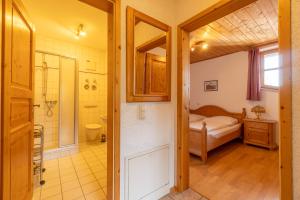 a bedroom with a bed and a bathroom with a shower at Lohberg Apartment in Lohberg