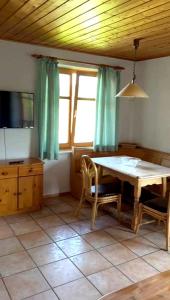 a dining room with a table and a tv at Lohberg Apartment in Lohberg
