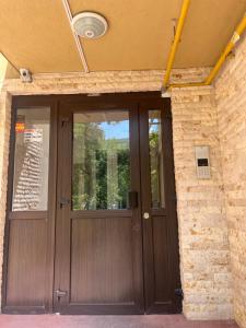 a wooden door in a brick building with a window at CX Family Apartment in Bucharest