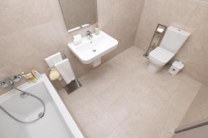 an overhead view of a bathroom with a toilet and a sink at Elmswater court in St. Paul's Bay +13 photos
