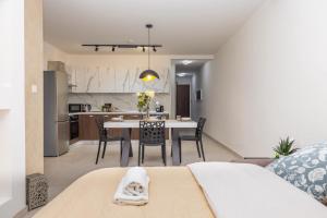 a living room and kitchen with a table and chairs at Elmswater court in St. Paul's Bay