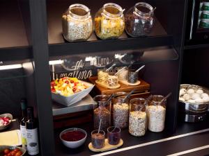 a pantry filled with jars of food and vegetables at B&B Hotel Augsburg-West in Augsburg