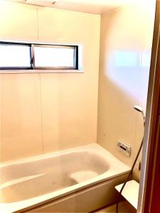 a white bath tub in a bathroom with a window at Minamikoma-gun - House - Vacation STAY 19040 in Kajikazawa +34 photos