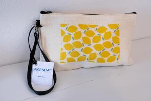 a pillow with a sign hanging on a wall at Ifigeneia Premium Villa in Limenaria