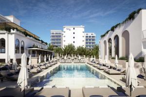 a pool with chaise lounges and chairs at Smy Portocolom - Renovated 2026 in Portocolom