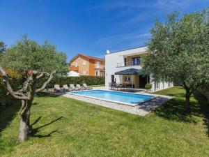 Holiday home Fiorini by SeeAdria Agency في Fiorini: حديقة خلفية مع حمام سباحة ومنزل