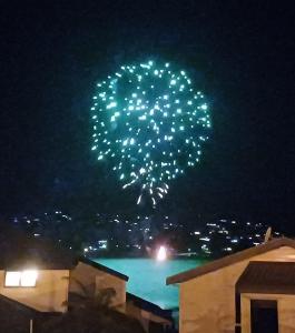 a firework display in the sky over a pool at night at Driftwood Sands 3 Brm in Tairua