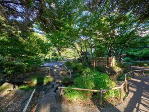 a garden with trees and a path with rocks at RetroSpect Stay Yokohama - Vacation STAY 03277v in Yokohama