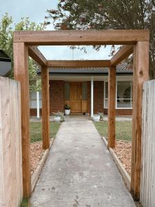 a wooden pergola in front of a house at Lonny Coastal Escape in Point Lonsdale +7 photos