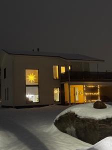 a building with a star in the windows at night at Villa Hattara in Rovaniemi