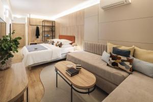 a hotel room with a couch and a bed at Hotel Waterman Kaktus in Supetar +36 photos
