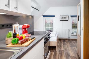 a kitchen with a counter with vegetables on a cutting board at Ferienwohnung Krabbe in Manslagt