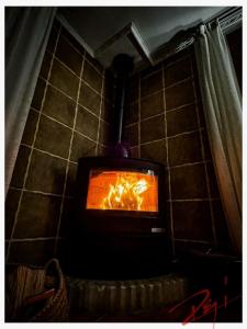 a stove in a room with a fire in it at Wonderful Villa, Heated Pool, Near Beautiful Town in Alboy