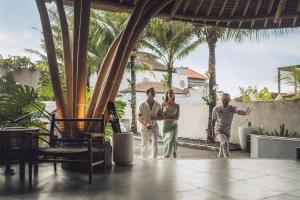 a group of people standing in a courtyard at Amarea Resort & Spa Ubud by Ini Vie Hospitality in Ubud