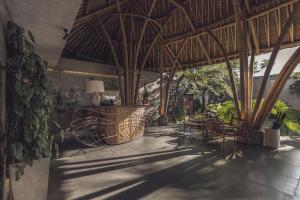 a room with a patio with chairs and trees at Amarea Resort & Spa Ubud by Ini Vie Hospitality in Ubud