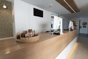 a counter in a room with baskets of flowers on it at Kyriad Montpellier Sud - Lattes in Montpellier