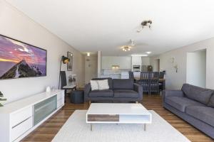 a living room with a couch and a table at Beach side Cotton Tree Family Friendly Resort in Maroochydore