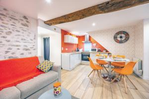 a living room with a couch and a table and chairs at Les Glycines N1 in Les Épesses +14 photos