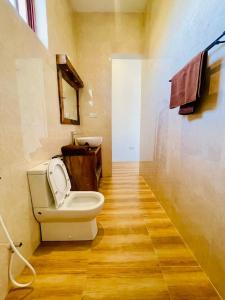 a bathroom with a toilet and a sink at Leo Home in Nungwi
