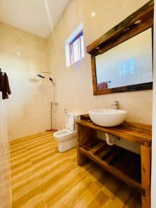 a bathroom with a sink and a toilet at Leo Home in Nungwi +1 photo