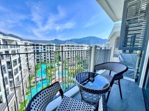 a balcony with two chairs and a table with a view at Title Legendary 7 floor Mountain View in Bang Tao Beach