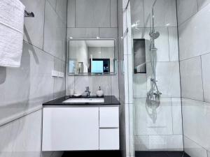 a white bathroom with a sink and a shower at Title Legendary 7 floor Mountain View in Bang Tao Beach +2 photos