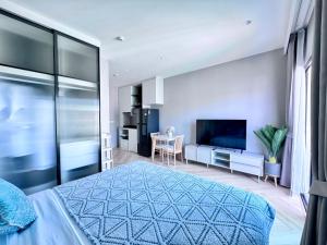 a bedroom with a bed and a flat screen tv at Title Legendary 7 floor Mountain View in Bang Tao Beach