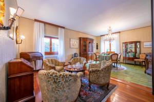 a living room with chairs and a table at Villa La Verbanina Private Garden - Happy Rentals in Ghiffa