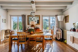 a dining room with a wooden table and chairs at Chambre D'hote Chez Amaya in Gujan-Mestras
