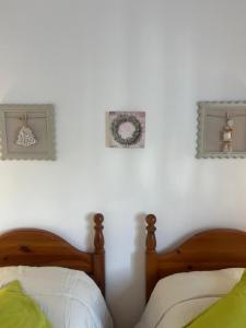 a bedroom with two beds and two pictures on the wall at B&b Cristina - Appartamento Monte Coccia in Campo di Giove