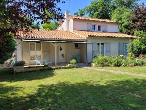 ein Haus mit einem Rasen davor in der Unterkunft Maison proche commerce, 20 min du Futuroscope in Vouillé