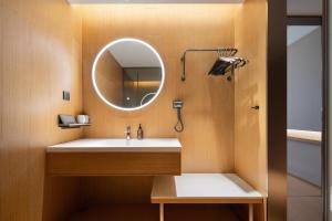 a bathroom with a sink and a mirror at JI Hotel Hangzhou Xiaoshan Chaoyang Subway Station in Hangzhou