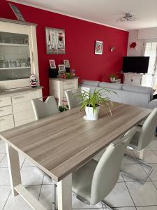 a dining room with a wooden table and chairs at Chambre d'hote Reine in Cancale