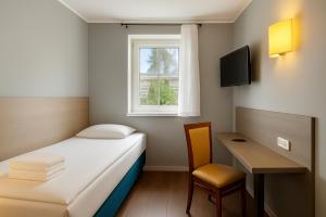 TV a/nebo společenská místnost v ubytování AR Boutique Hotel Heusenstamm