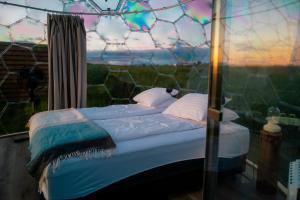 a bed in a room with a fence at Aurora Igloo North in Hvammstangi +10 photos