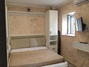 Postel nebo postele na pokoji v ubytování Casa Vacanze Sannazzaro Flat